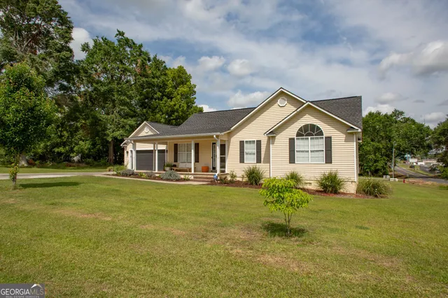 a front view of house with yard and green space