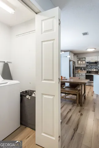 a view of kitchen with furniture and wooden floor