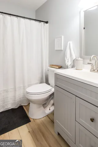 a bathroom with a toilet and a shower curtain