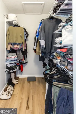 a spacious bathroom with a tub sink and a mirror