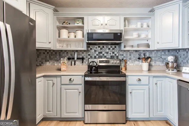 a kitchen with a stove oven and sink