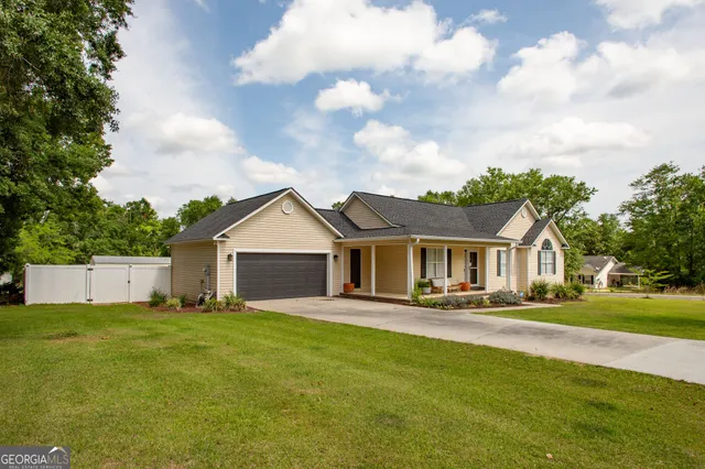 a front view of house with yard and green space