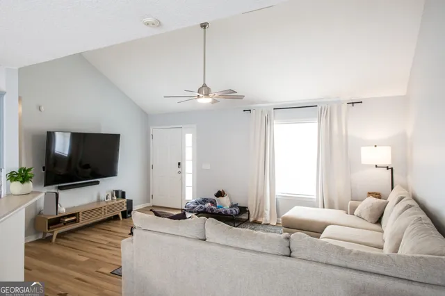 a living room with furniture and a flat screen tv