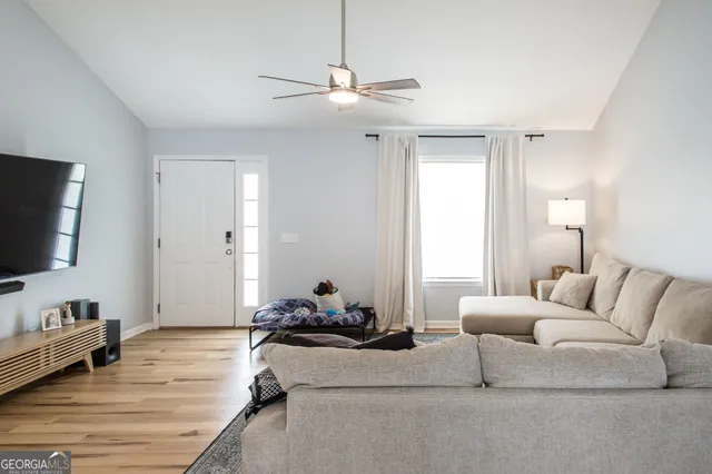 a living room with furniture and a flat screen tv
