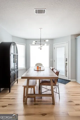 a view of a dining room with furniture window and wooden floor