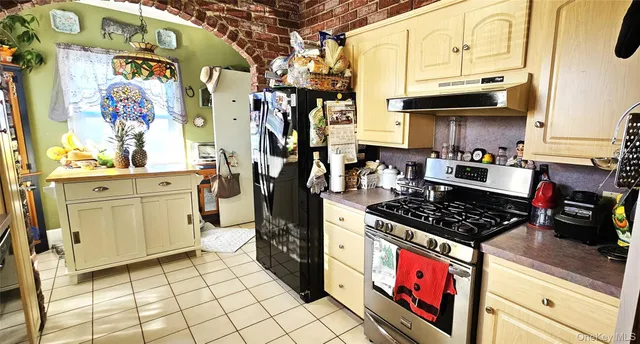 a kitchen with stainless steel appliances granite countertop a stove and cabinets
