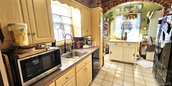 a kitchen with stainless steel appliances a stove a sink and a microwave