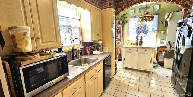a kitchen with stainless steel appliances a stove a sink and a microwave