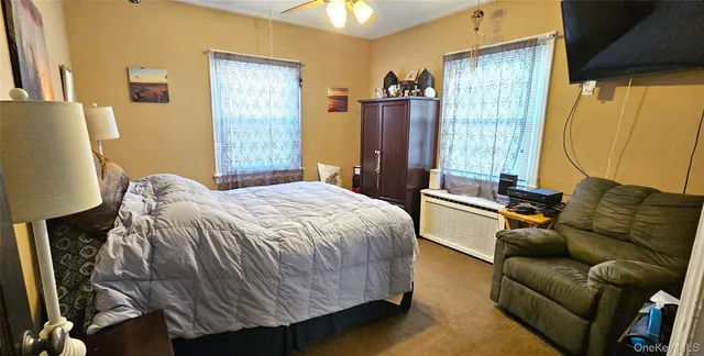 a bedroom with a bed couch and a window