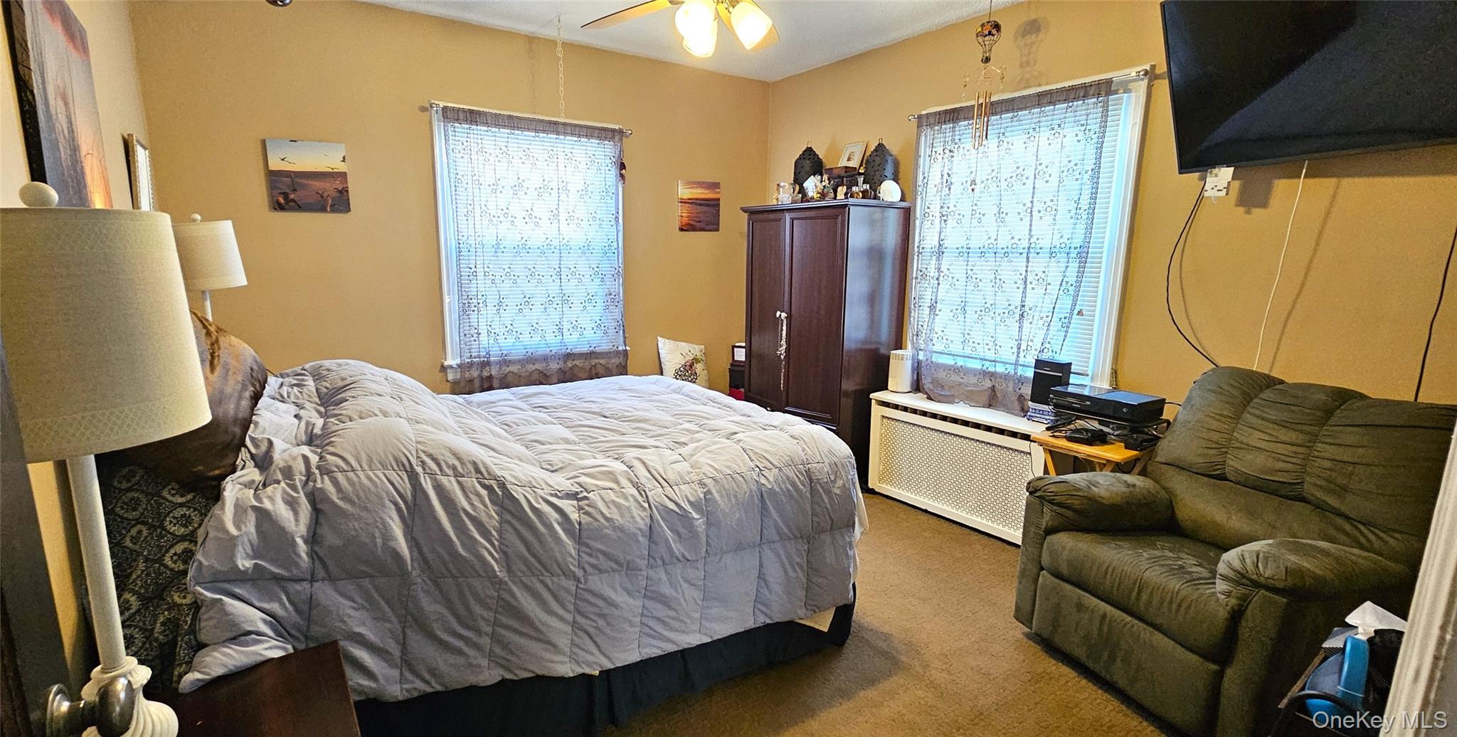 80 Dobson Avenue Merrick, NY 11566 - Photo 14 of 21 a bedroom with a bed couch and a window