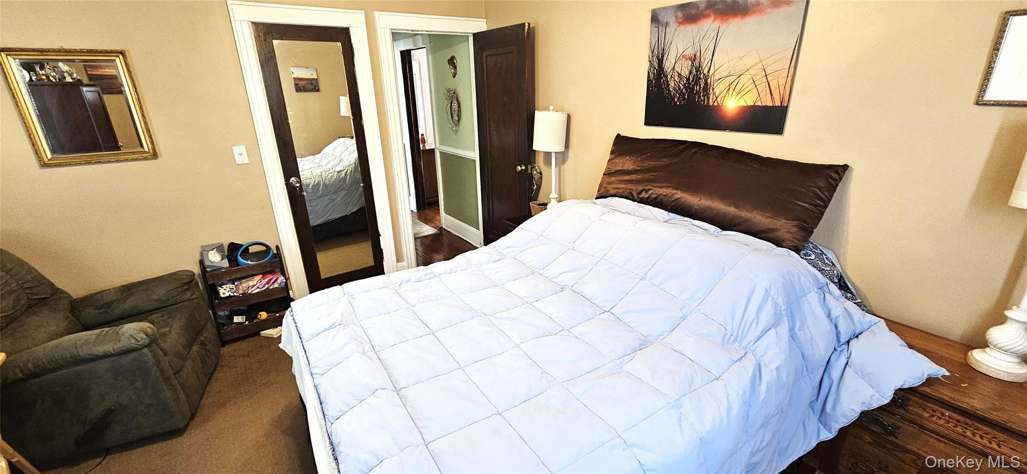 80 Dobson Avenue Merrick, NY 11566 - Photo 15 of 21 a bed sitting in a bedroom next to a window with pc on the wall