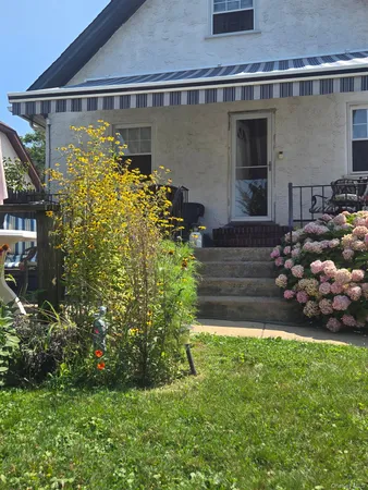 a front view of a house with garden