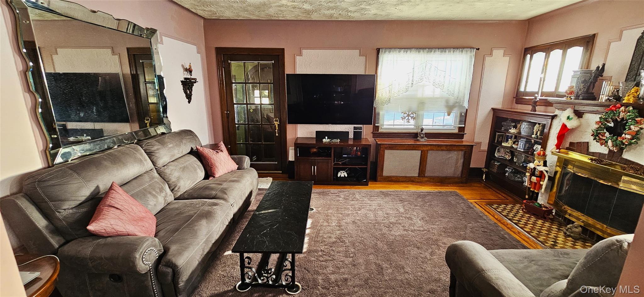 80 Dobson Avenue Merrick, NY 11566 - Photo 6 of 21 a living room with furniture and a flat screen tv
