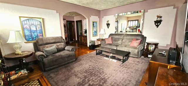 a living room with furniture a rug and a table