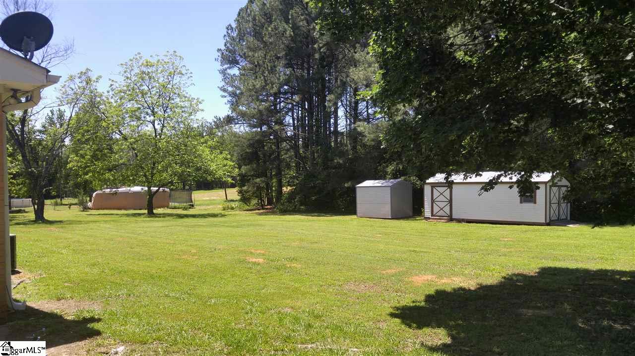 201 Baldwin Road Simpsonville, SC 29680 - Photo 4 of 24 Back yard has cleared area but also includes some woods. The larger outbuilding conveys wit the property!