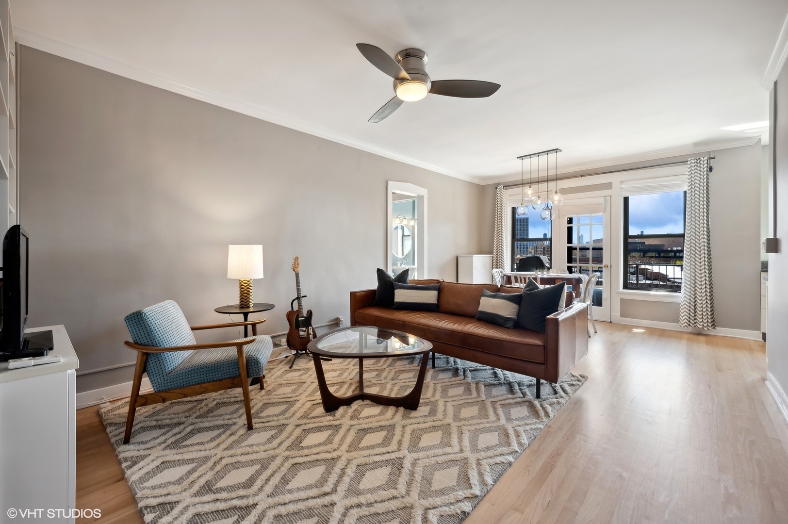 725 West Sheridan Road, Unit 603 Chicago, IL 60613 - Photo 2 of 16 a living room with fireplace furniture and a wooden floor