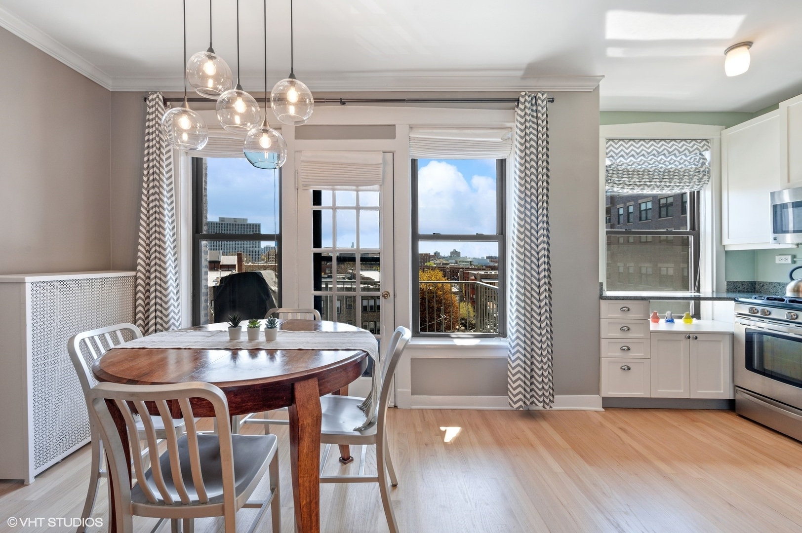 725 West Sheridan Road, Unit 603 Chicago, IL 60613 - Photo 5 of 16 a view of a dining room with furniture window and wooden floor