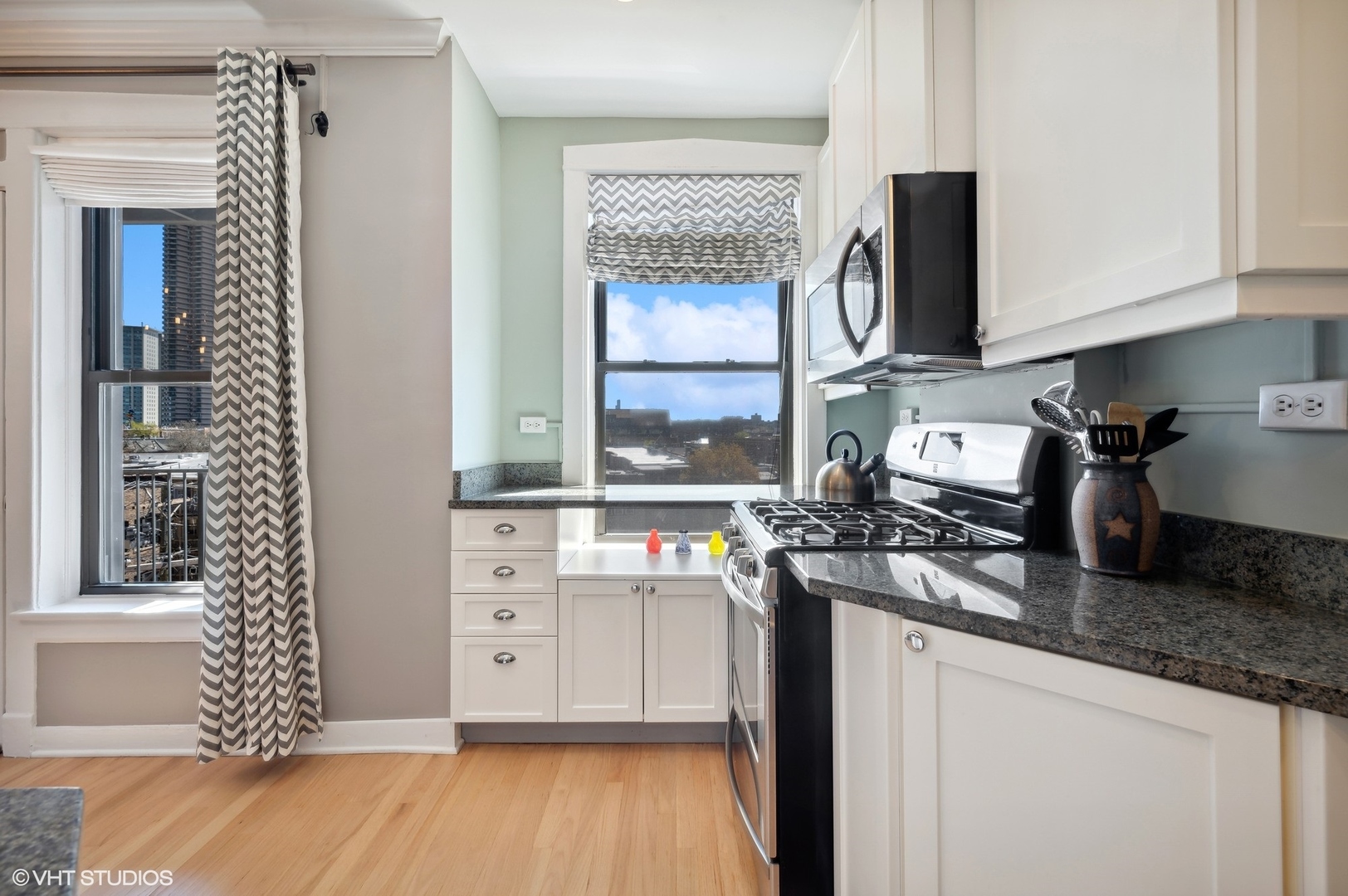 725 West Sheridan Road, Unit 603 Chicago, IL 60613 - Photo 7 of 16 a kitchen with stainless steel appliances granite countertop a sink stove and microwave