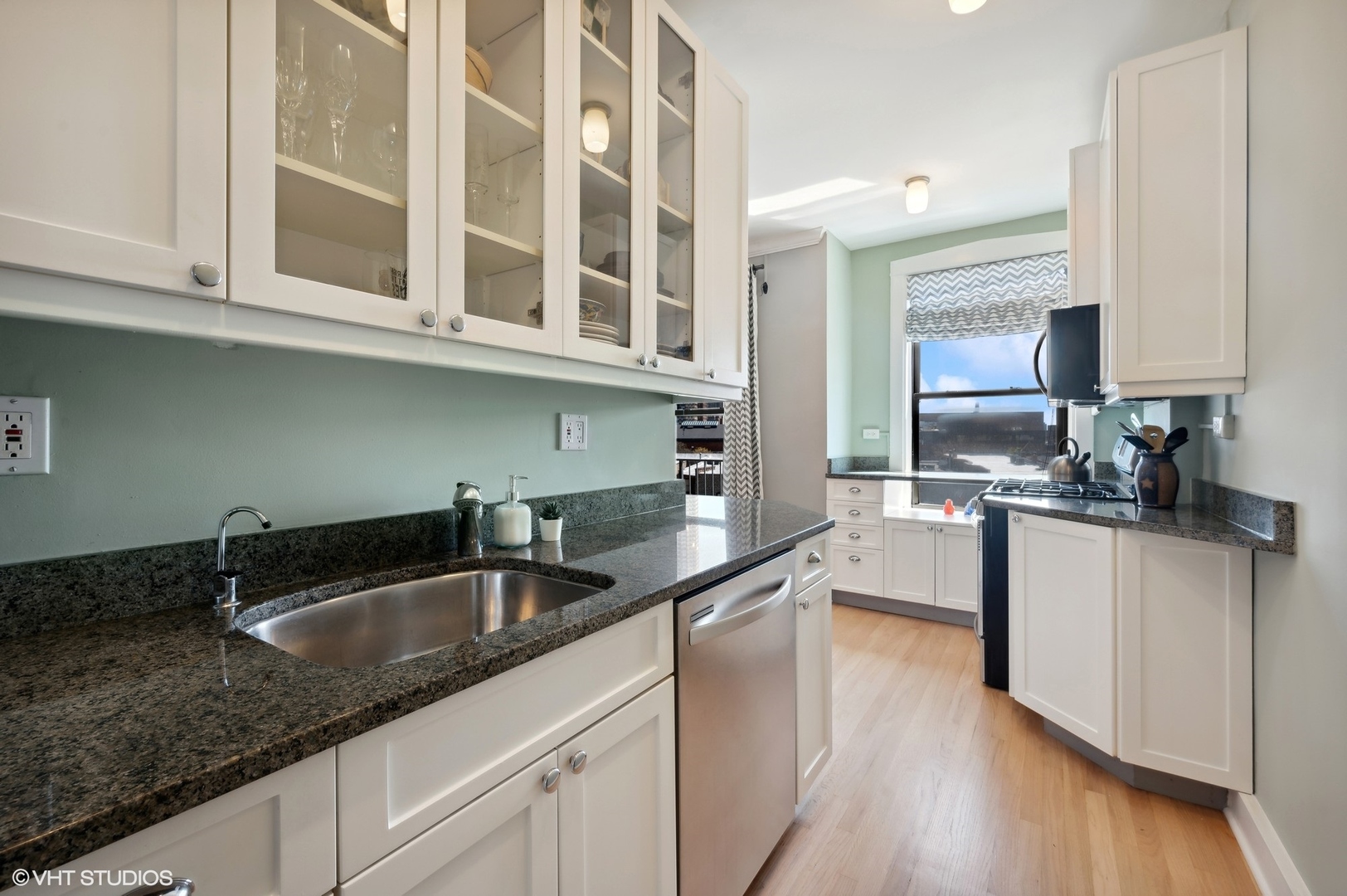 725 West Sheridan Road, Unit 603 Chicago, IL 60613 - Photo 8 of 16 a kitchen with granite countertop a sink and cabinets