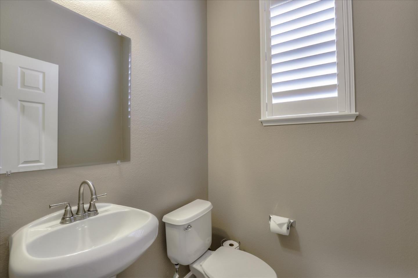 7820 Dickens Way Gilroy, CA 95020 - Photo 13 of 27 a bathroom with a sink mirror and toilet