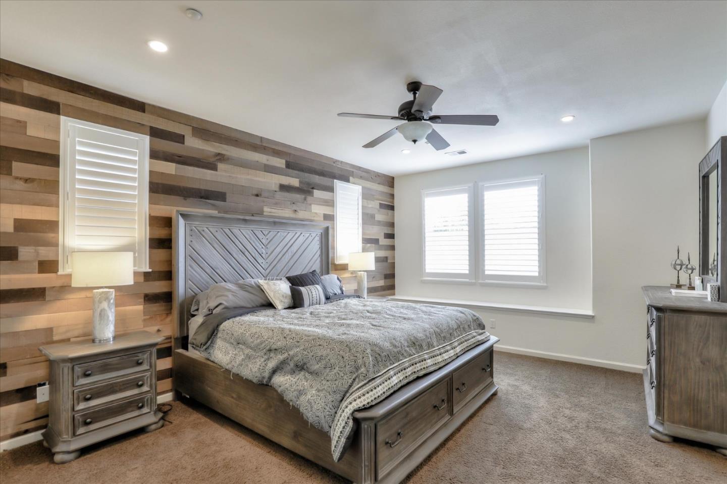 7820 Dickens Way Gilroy, CA 95020 - Photo 16 of 27 a bedroom with a bed and a chandelier