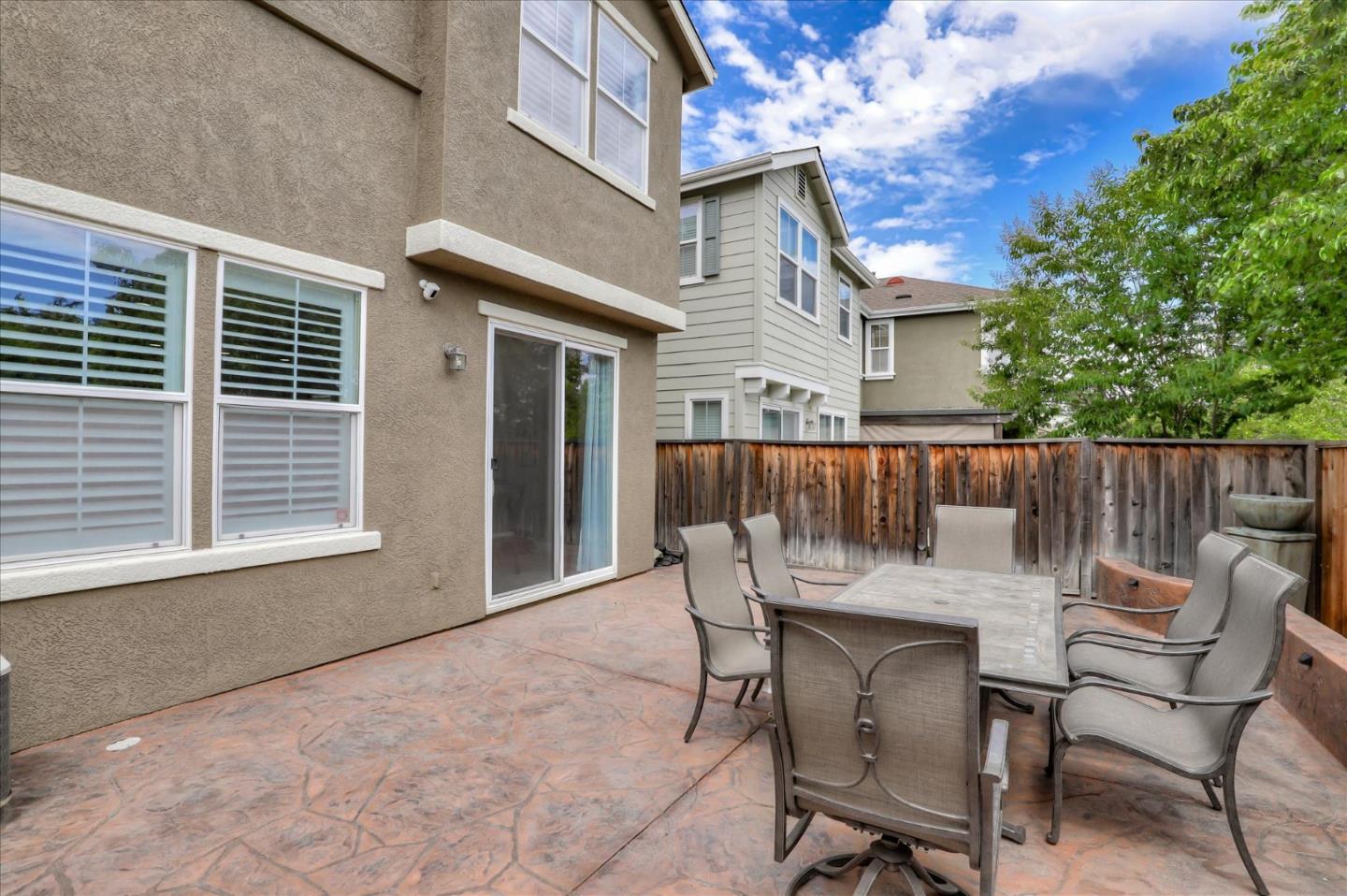 7820 Dickens Way Gilroy, CA 95020 - Photo 23 of 27 a view of a chairs and table in the back yard of the house