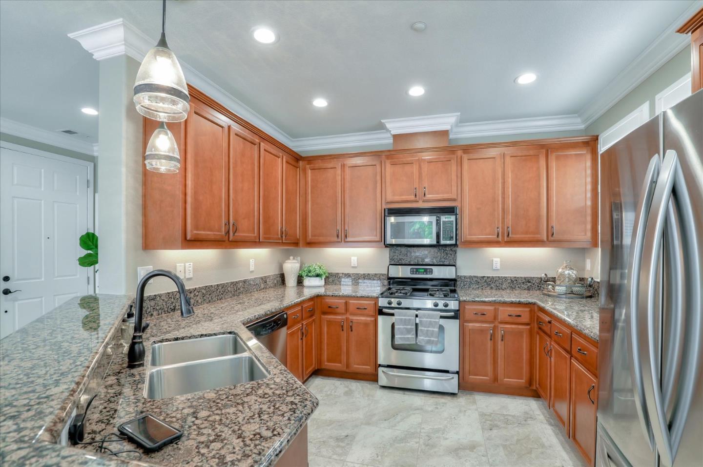 7820 Dickens Way Gilroy, CA 95020 - Photo 7 of 27 a kitchen with granite countertop a sink stainless steel appliances and cabinets