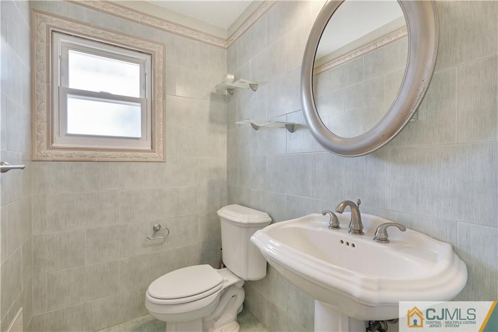34 Mercer Road Old Bridge, NJ 08857 - Photo 14 of 27 a bathroom with a sink a toilet and a mirror
