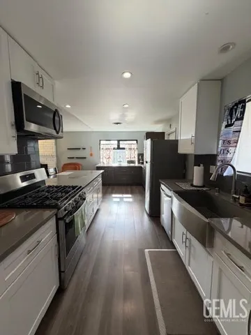 a large kitchen with stainless steel appliances