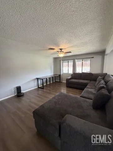 a living room with furniture and a book shelf
