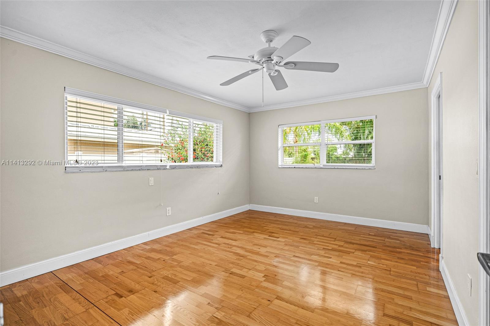 1260 Southwest 9th Street Boca Raton, FL 33486 - Photo 15 of 40 a view of an empty room with wooden floor and a window