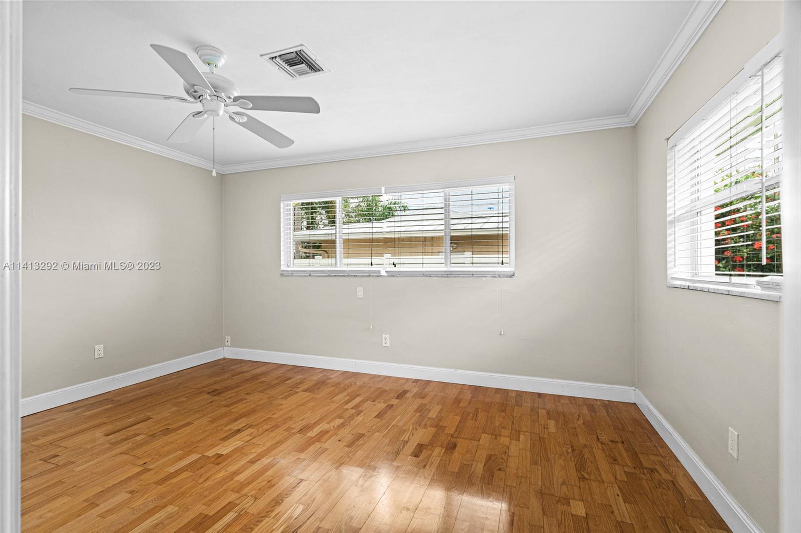 1260 Southwest 9th Street Boca Raton, FL 33486 - Photo 20 of 40 a view of an empty room with wooden floor and a window