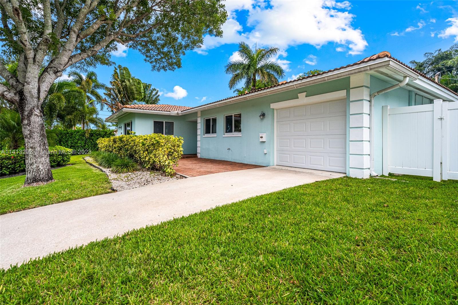 1260 Southwest 9th Street Boca Raton, FL 33486 - Photo 2 of 40 a front view of a house with garden