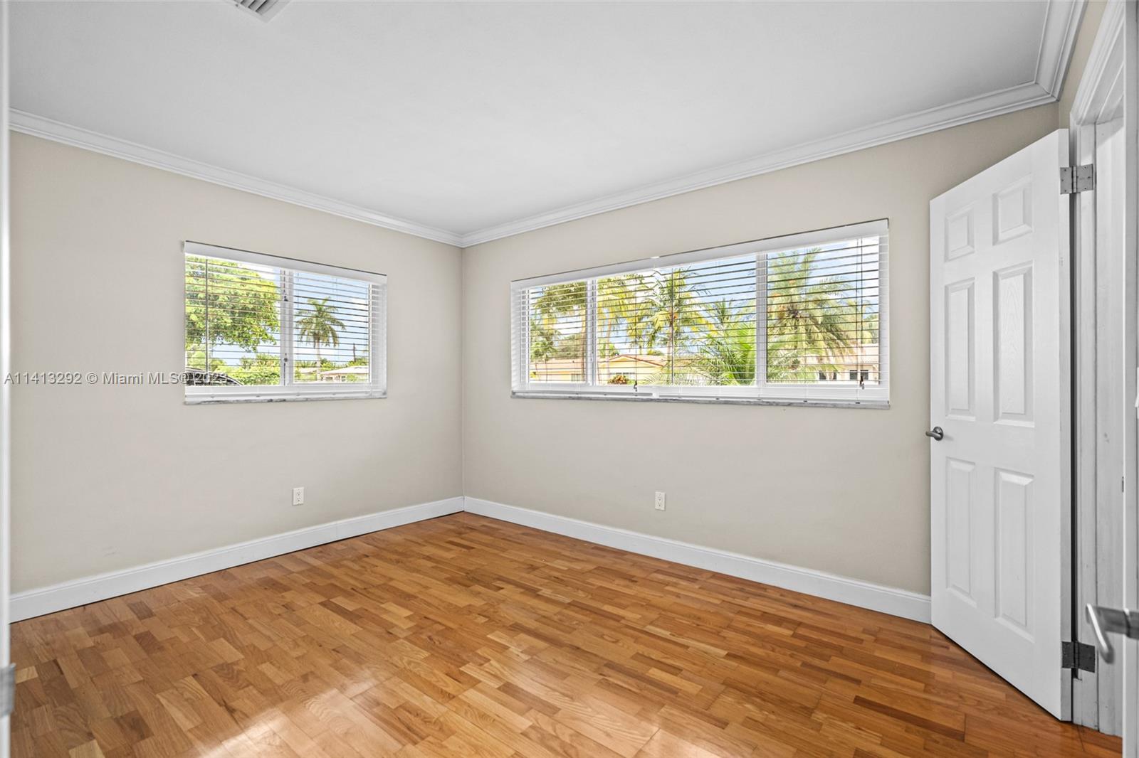 1260 Southwest 9th Street Boca Raton, FL 33486 - Photo 21 of 40 a view of an empty room with wooden floor and a window