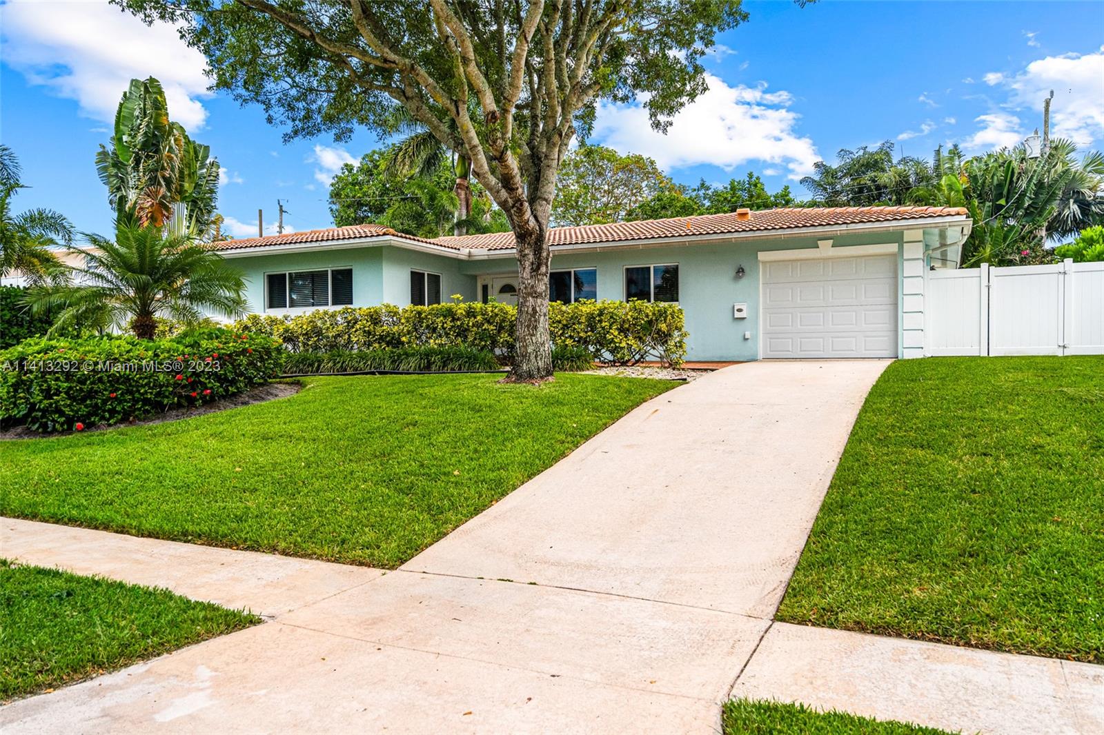 1260 Southwest 9th Street Boca Raton, FL 33486 - Photo 34 of 40 a front view of a house with a garden