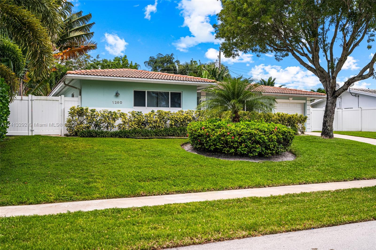 1260 Southwest 9th Street Boca Raton, FL 33486 - Photo 35 of 40 a front view of a house with a garden