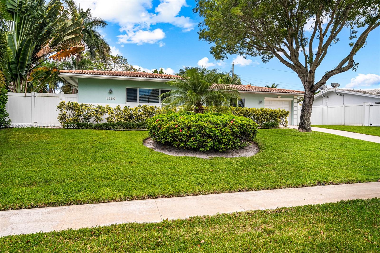 1260 Southwest 9th Street Boca Raton, FL 33486 - Photo 37 of 40 a front view of a house with a garden