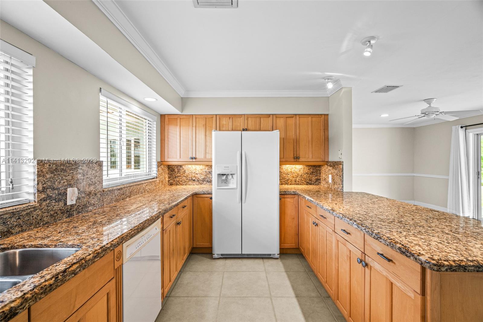 1260 Southwest 9th Street Boca Raton, FL 33486 - Photo 7 of 40 a kitchen with stainless steel appliances granite countertop a sink stove and refrigerator