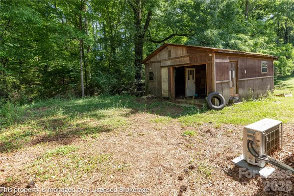 a view of a barn in the middle of a yard