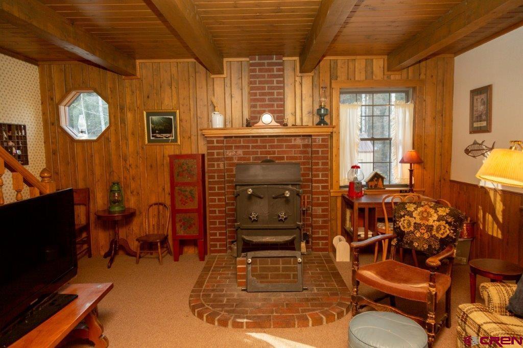 231 Forest Road Creede, CO 81130 - Photo 12 of 31 a living room with furniture a flat screen tv and a fireplace