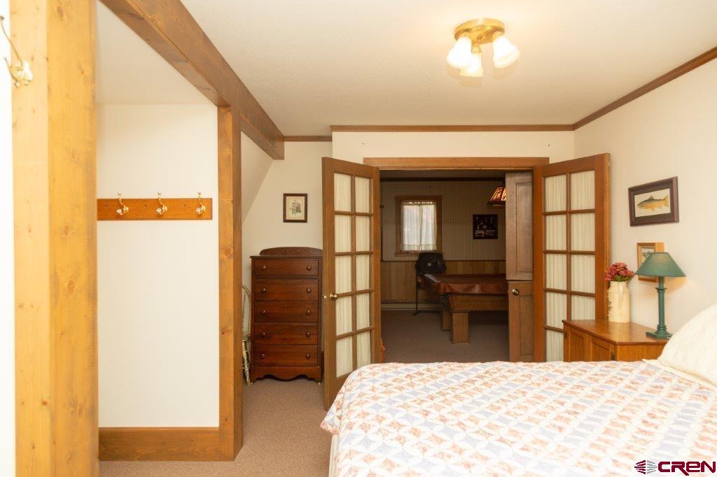 231 Forest Road Creede, CO 81130 - Photo 15 of 31 a bedroom with a bed and a television