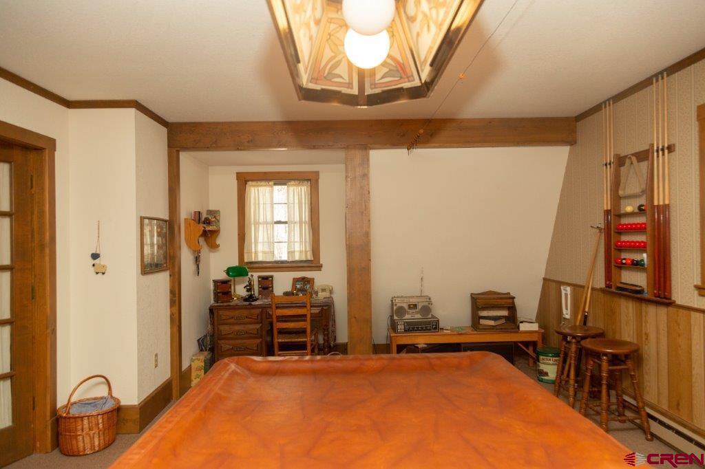 231 Forest Road Creede, CO 81130 - Photo 19 of 31 a room with gym equipment and a chandelier