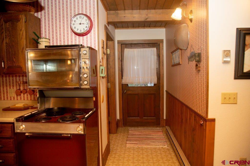 231 Forest Road Creede, CO 81130 - Photo 20 of 31 a kitchen with a stove and a refrigerator