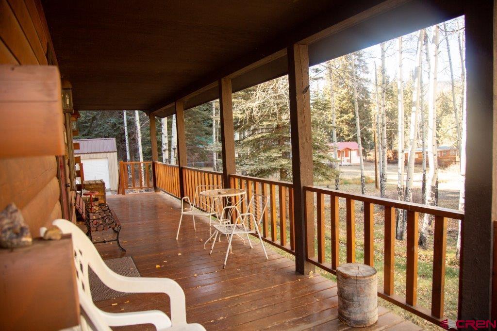 231 Forest Road Creede, CO 81130 - Photo 22 of 31 a dining room with furniture water view and a floor to ceiling window