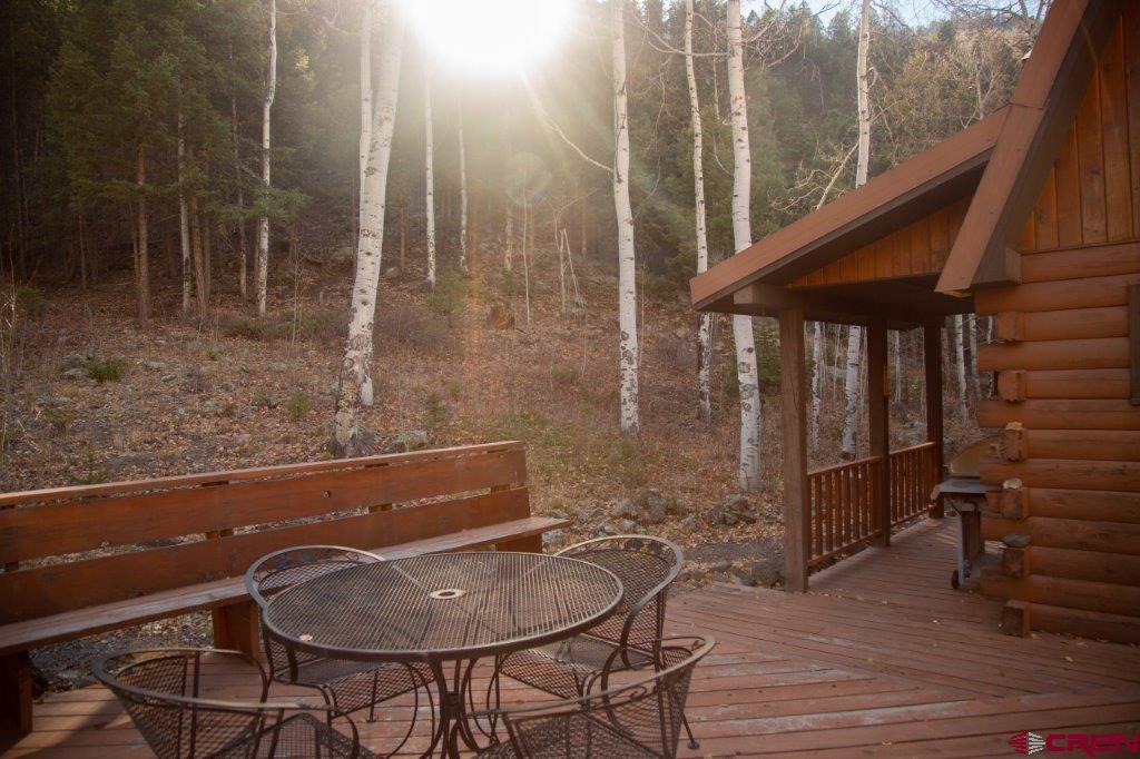 231 Forest Road Creede, CO 81130 - Photo 28 of 31 a backyard of a house with table and chairs