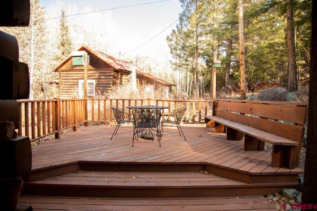 231 Forest Road Creede, CO 81130 - Photo 29 of 31 a view of a patio with table and chairs with wooden floor and fence