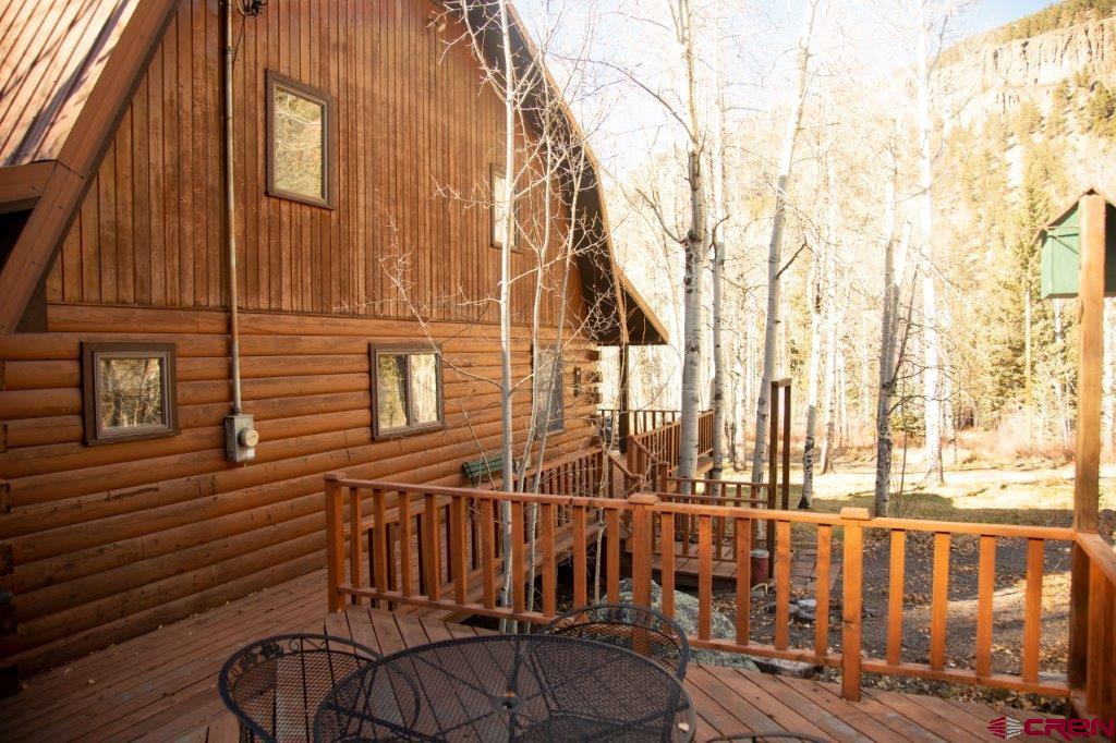 231 Forest Road Creede, CO 81130 - Photo 30 of 31 a view of a brick house with a small backyard