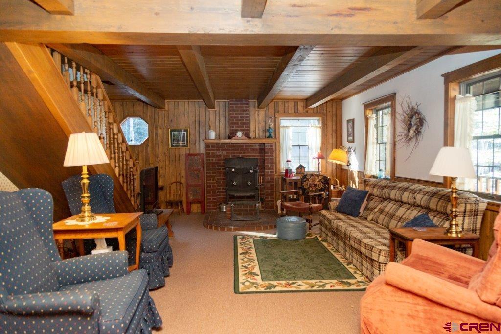 231 Forest Road Creede, CO 81130 - Photo 7 of 31 a living room with furniture a rug and a clock