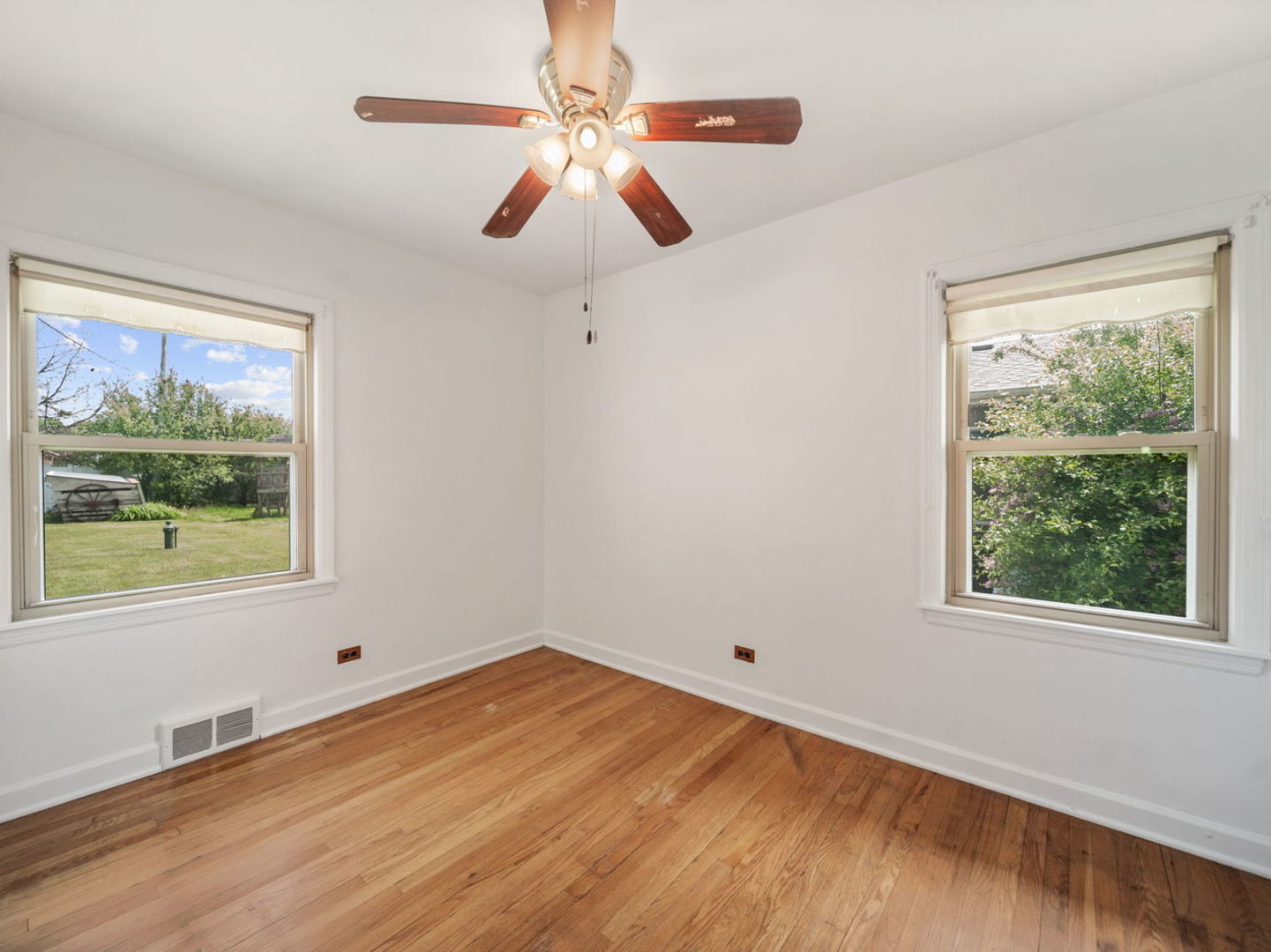 4N365 9th Avenue Addison, IL 60101 - Photo 3 of 24 a view of empty room with wooden floor and fan