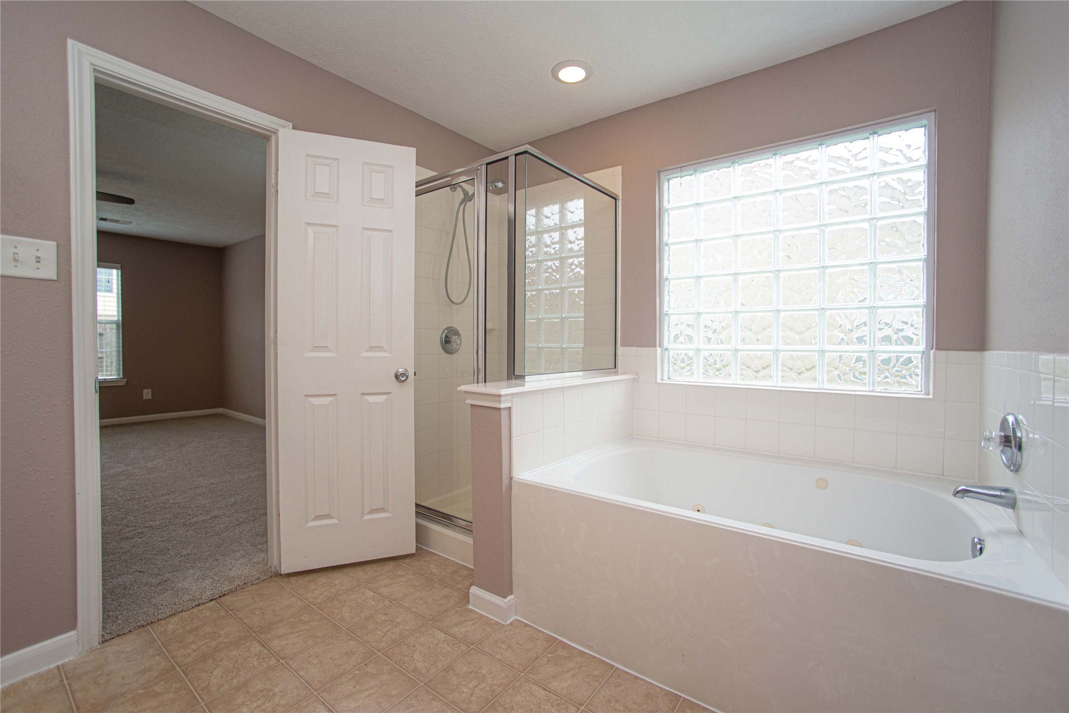 29314 Legends Bluff Drive Spring, TX 77386 - Photo 16 of 26 a bathroom with a bathtub and a shower